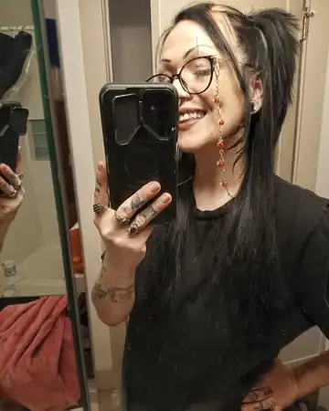 Therapissed creator smiling in a mirror selfie